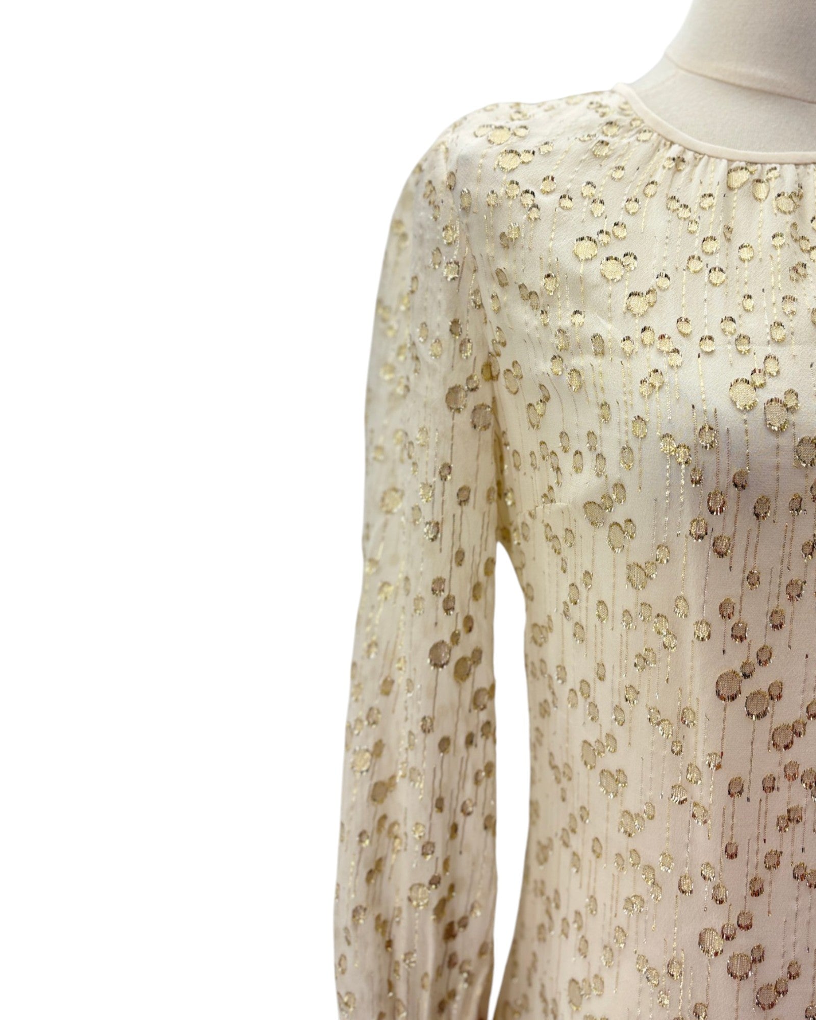 White dress with gold polka dot pattern on a white background