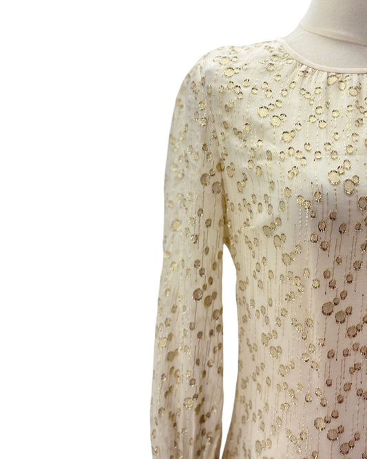 White dress with gold polka dot pattern on a white background