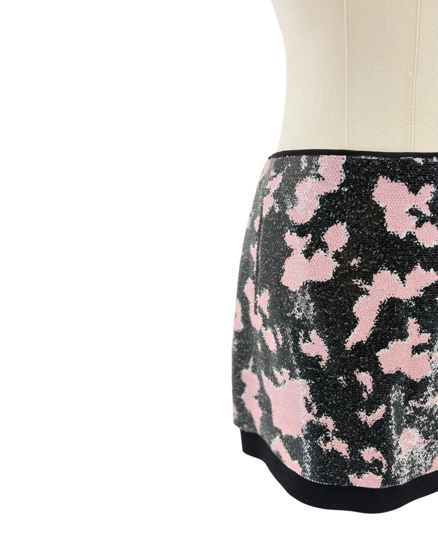 Black skirt with pink floral pattern on a white background