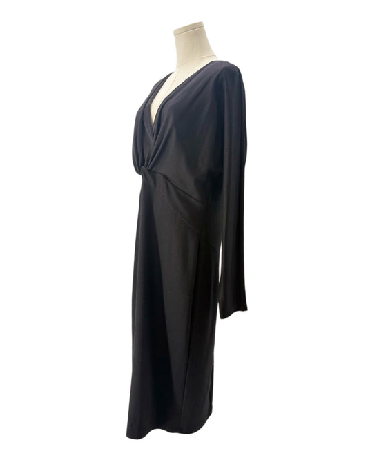 Black draped dress on a mannequin against a white background