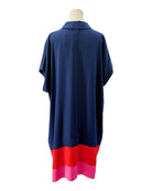 Navy blue dress with red and pink hem on a mannequin against a white background