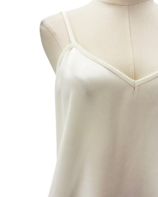 White sleeveless top on a mannequin with a white background