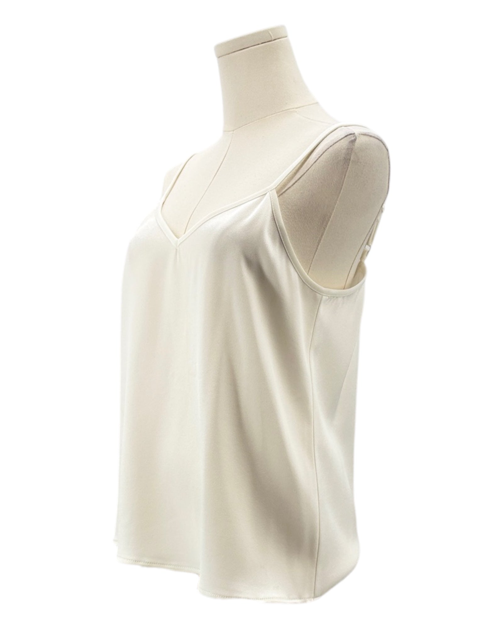 White sleeveless top on a mannequin against a white background