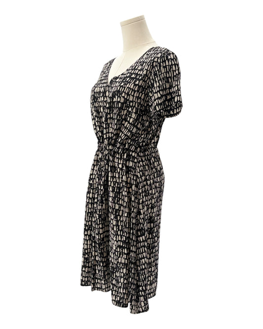 Black and white patterned dress on a mannequin against a white background