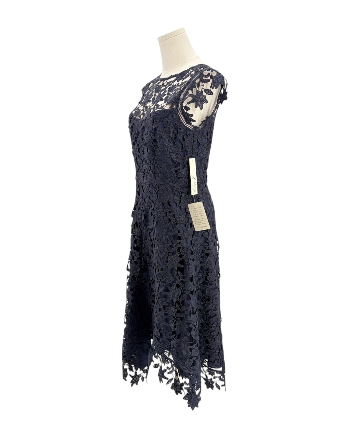 Navy lace dress on a mannequin with a white background