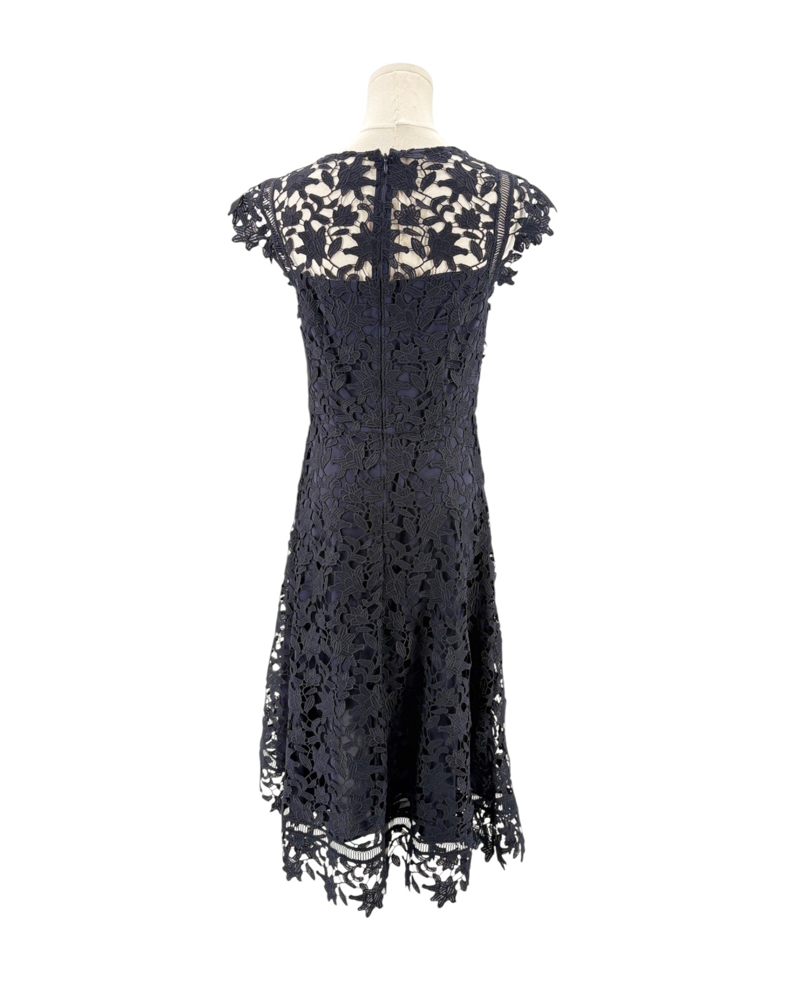 Navy lace dress on a mannequin against a white background