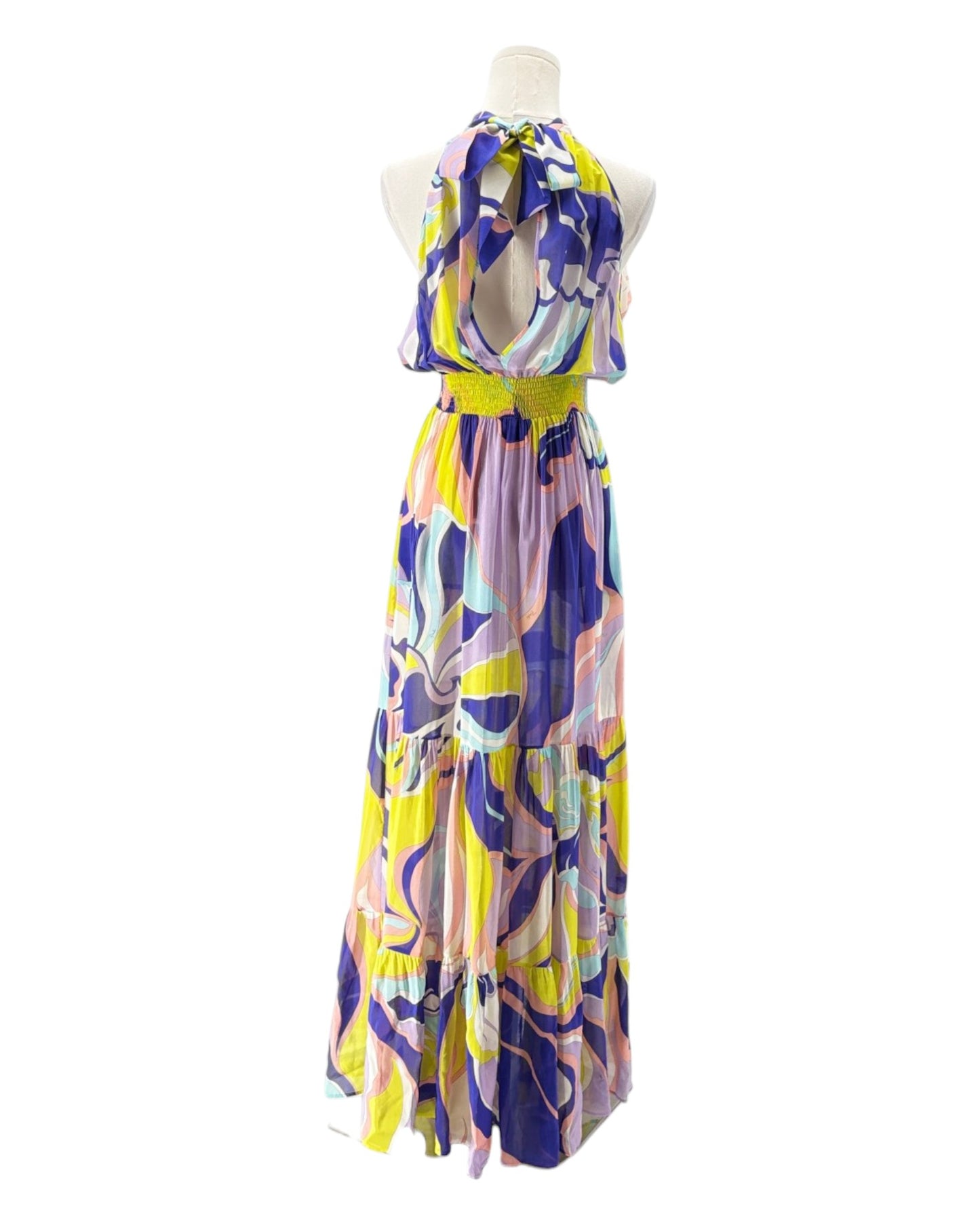 Colorful patterned dress on a mannequin against a white background