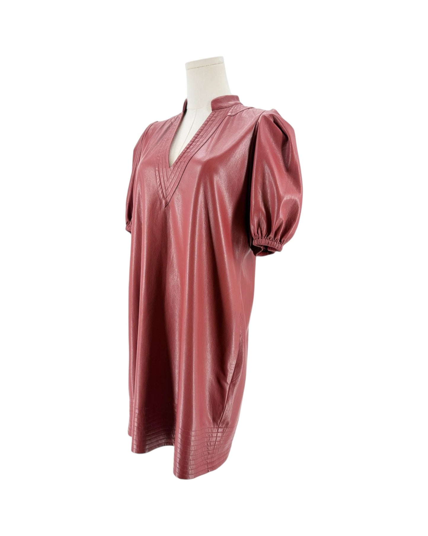 A brick red faux leather tunic top with puff sleeves and a split V-neckline, displayed on a mannequin torso against a white background.