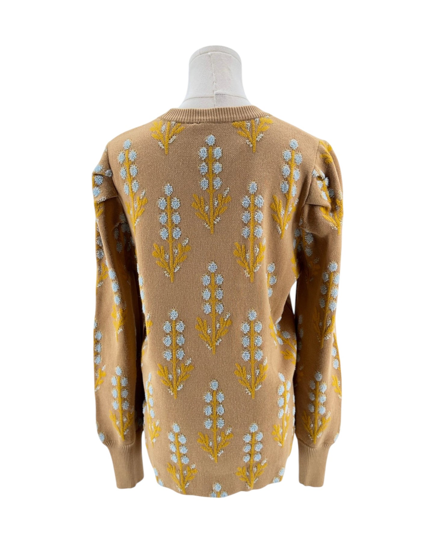 Beige sweater with floral pattern on a mannequin against a white background
