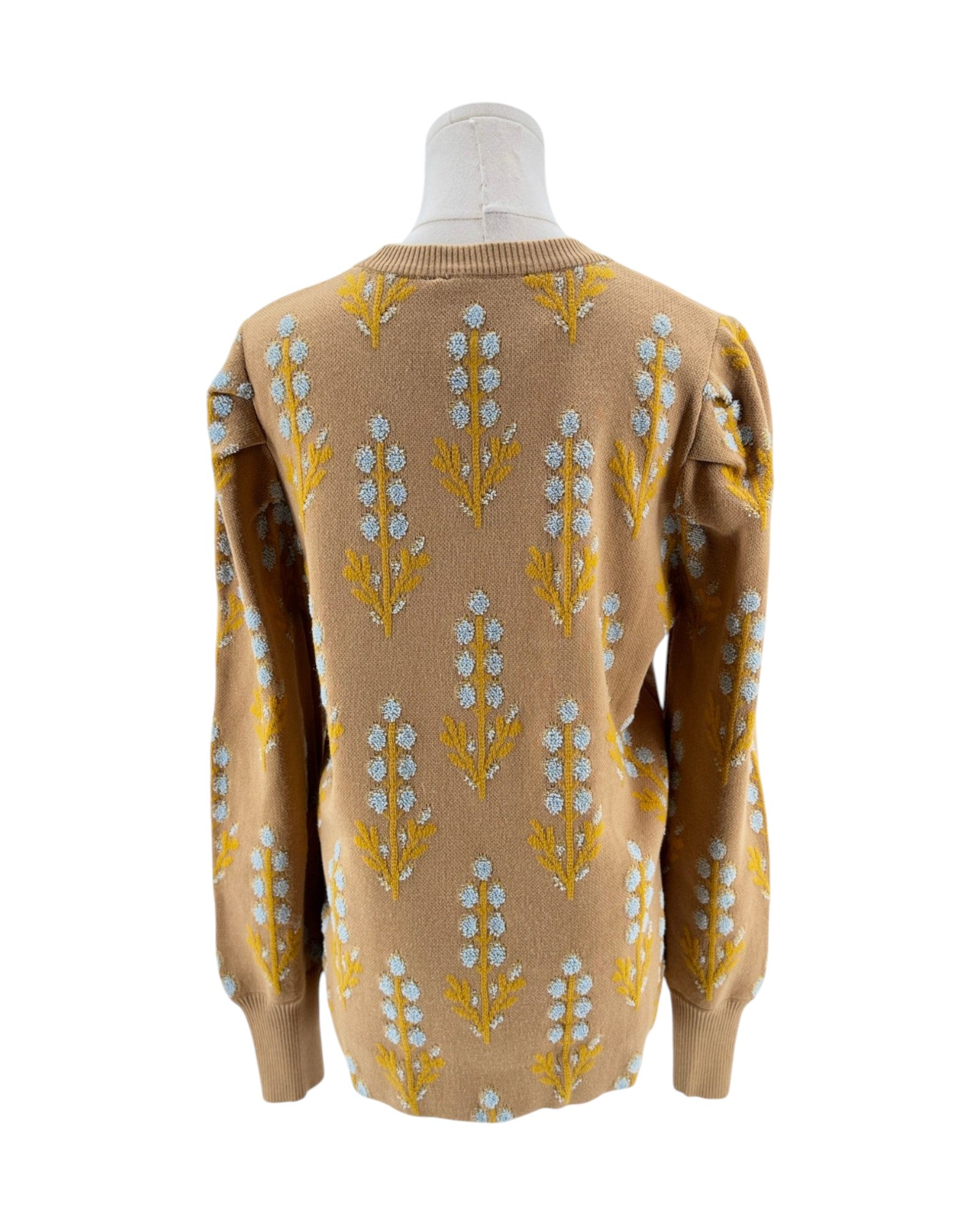 Beige sweater with floral pattern on a mannequin against a white background