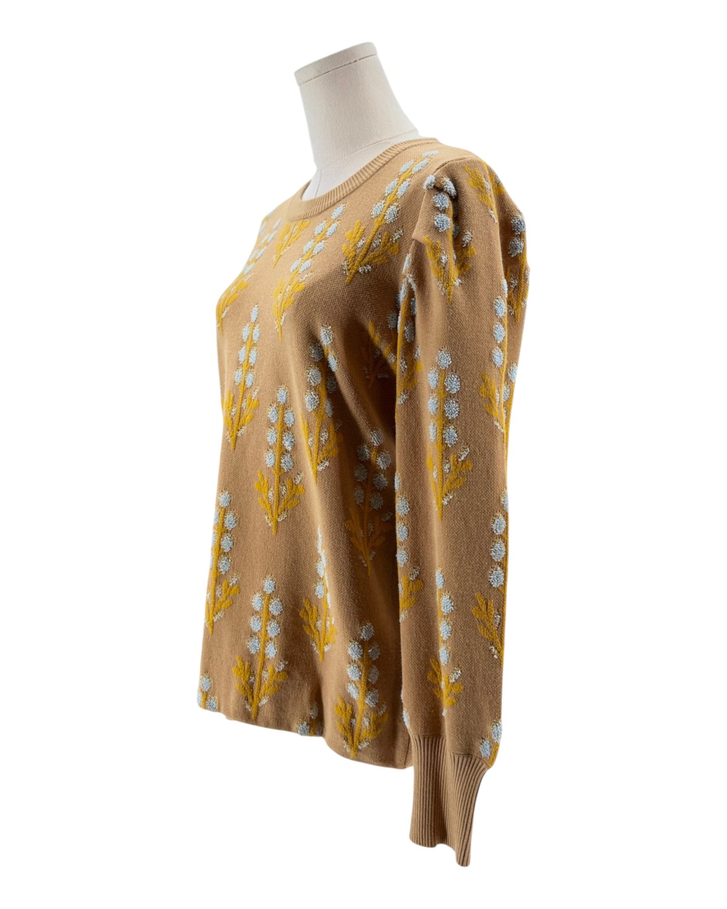 Brown sweater with yellow floral patterns on a mannequin against a white background