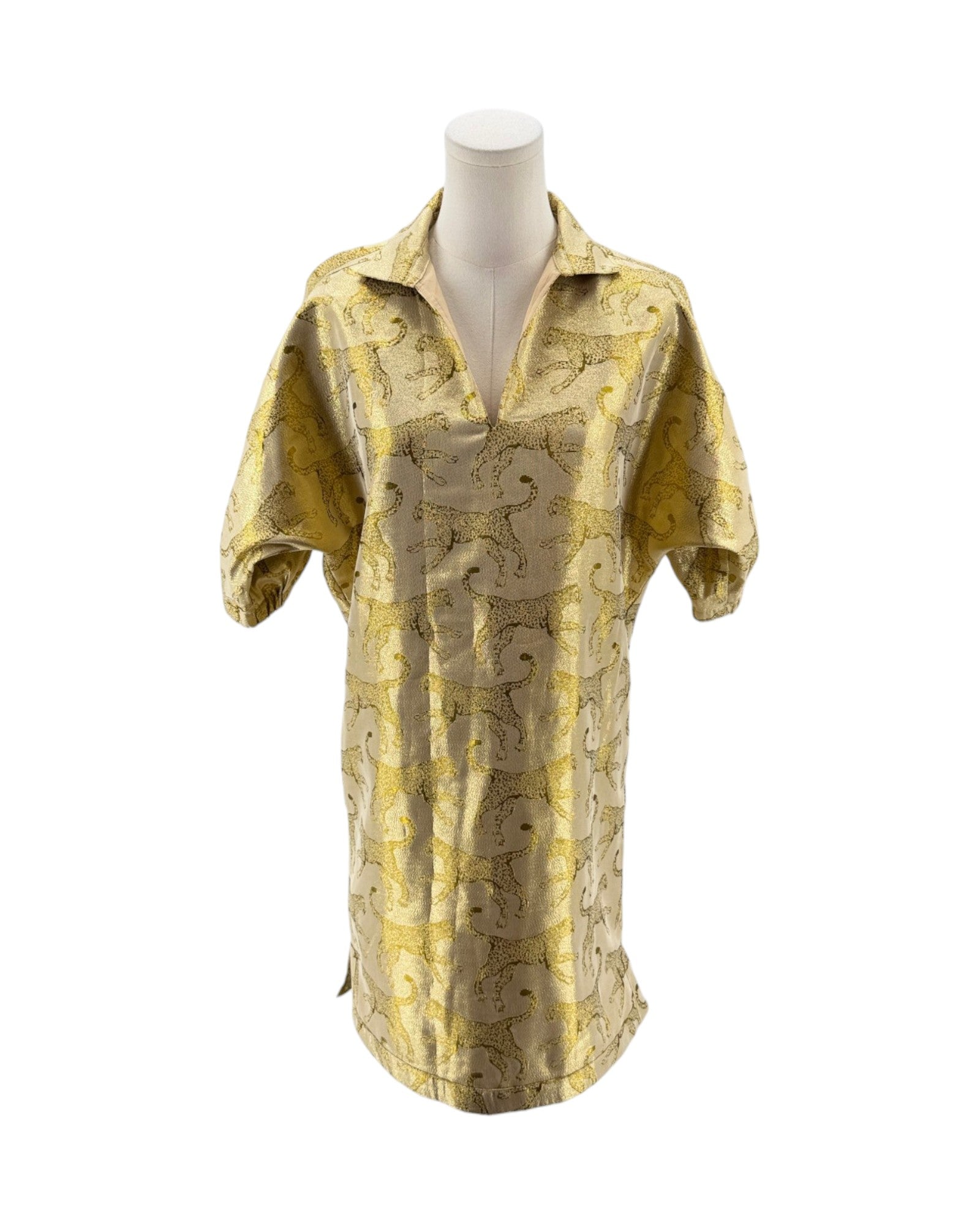 Gold patterned shirt on a mannequin against a white background