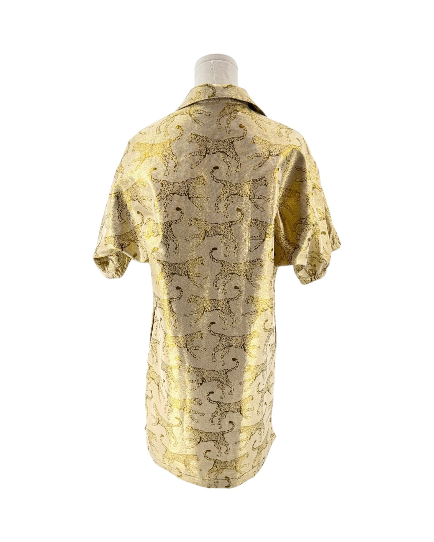 Mannequin wearing a yellow and animal patterned robe on a white background