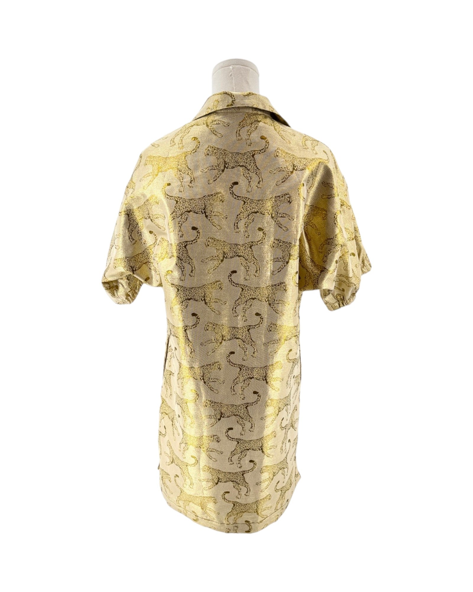 Mannequin wearing a yellow and animal patterned robe on a white background