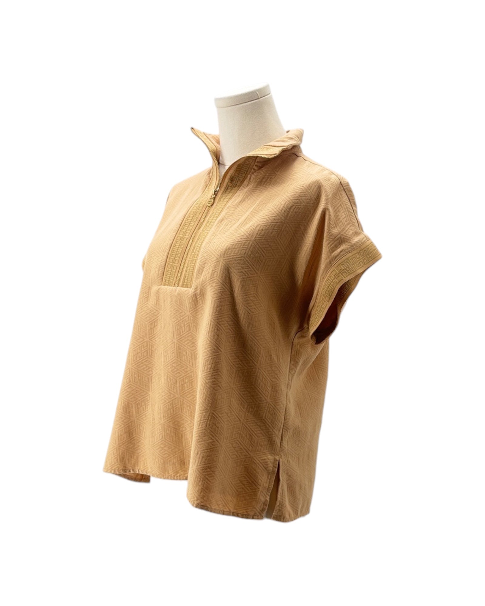 Gold short-sleeve shirt on a mannequin against a white background