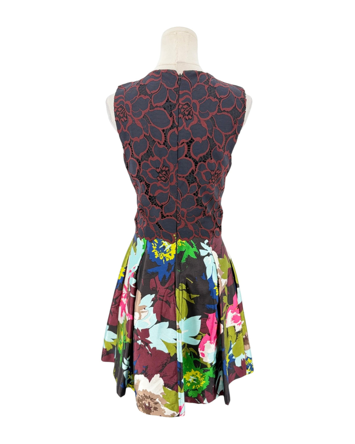 A sleeveless fit-and-flare dress displayed on a mannequin against a white background. The bodice features a dark red and black floral lace overlay, while the flared skirt has a vibrant multicolor floral print with pink, blue, green, and yellow tones.