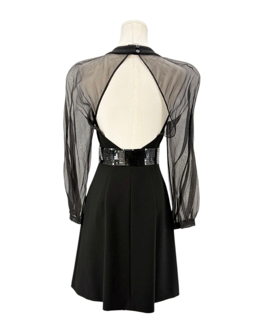 Black dress with sheer sleeves on a mannequin against a white background