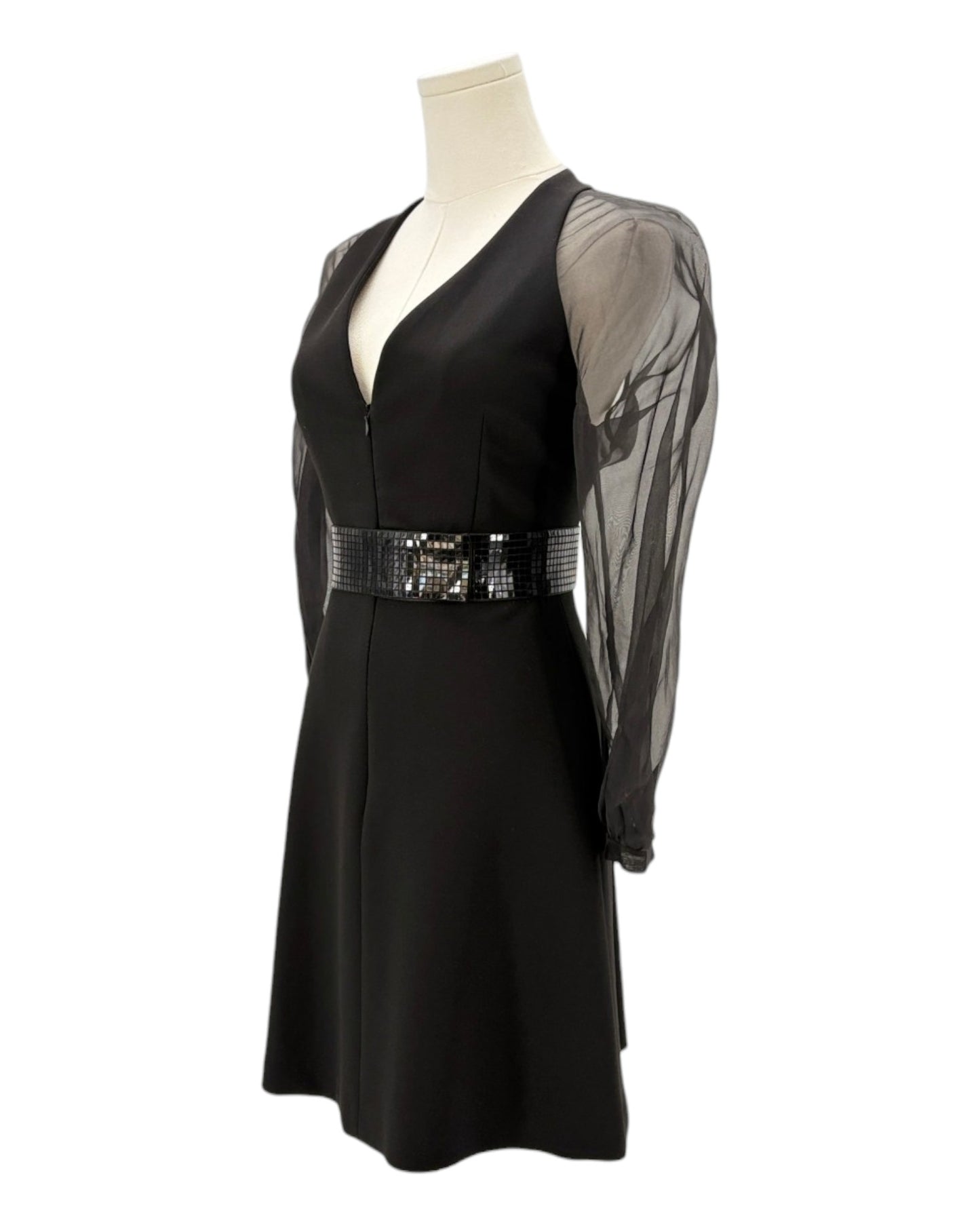 Black dress with sheer sleeves and sequined belt on a mannequin against a white background