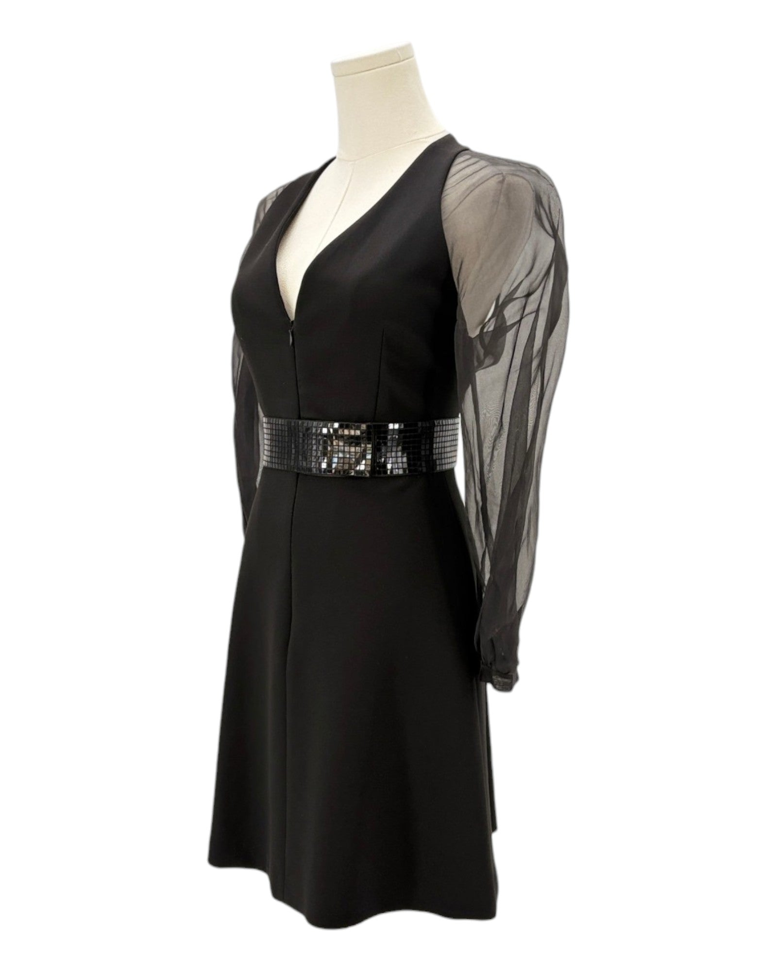 Black dress with sheer sleeves and sequined belt on a mannequin against a white background