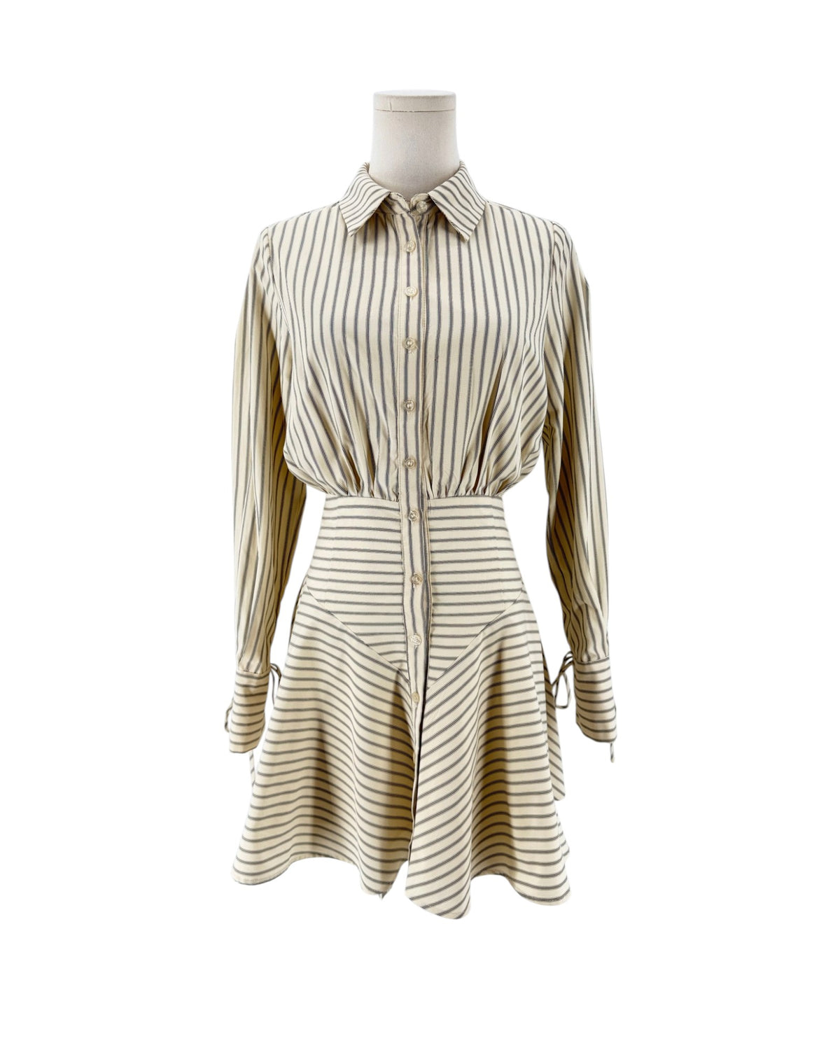 Striped shirt dress, point collar, clean button-front placket closure, distinct smocked and gathered detailing, long sleeves detailed with adjustable drawstring/tie accent at cuffs on a mannequin on a white background