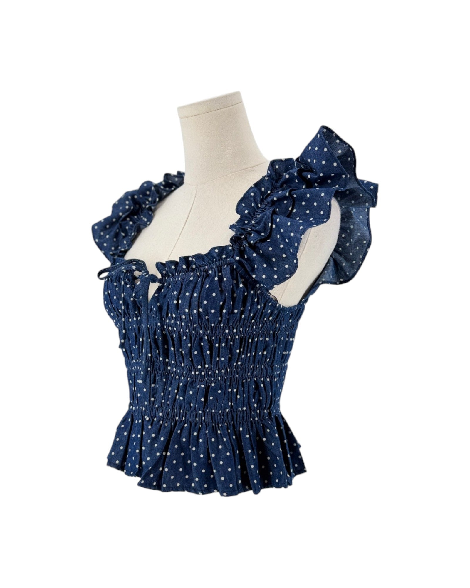 Blue polka dot flutter sleeve top on a white background
