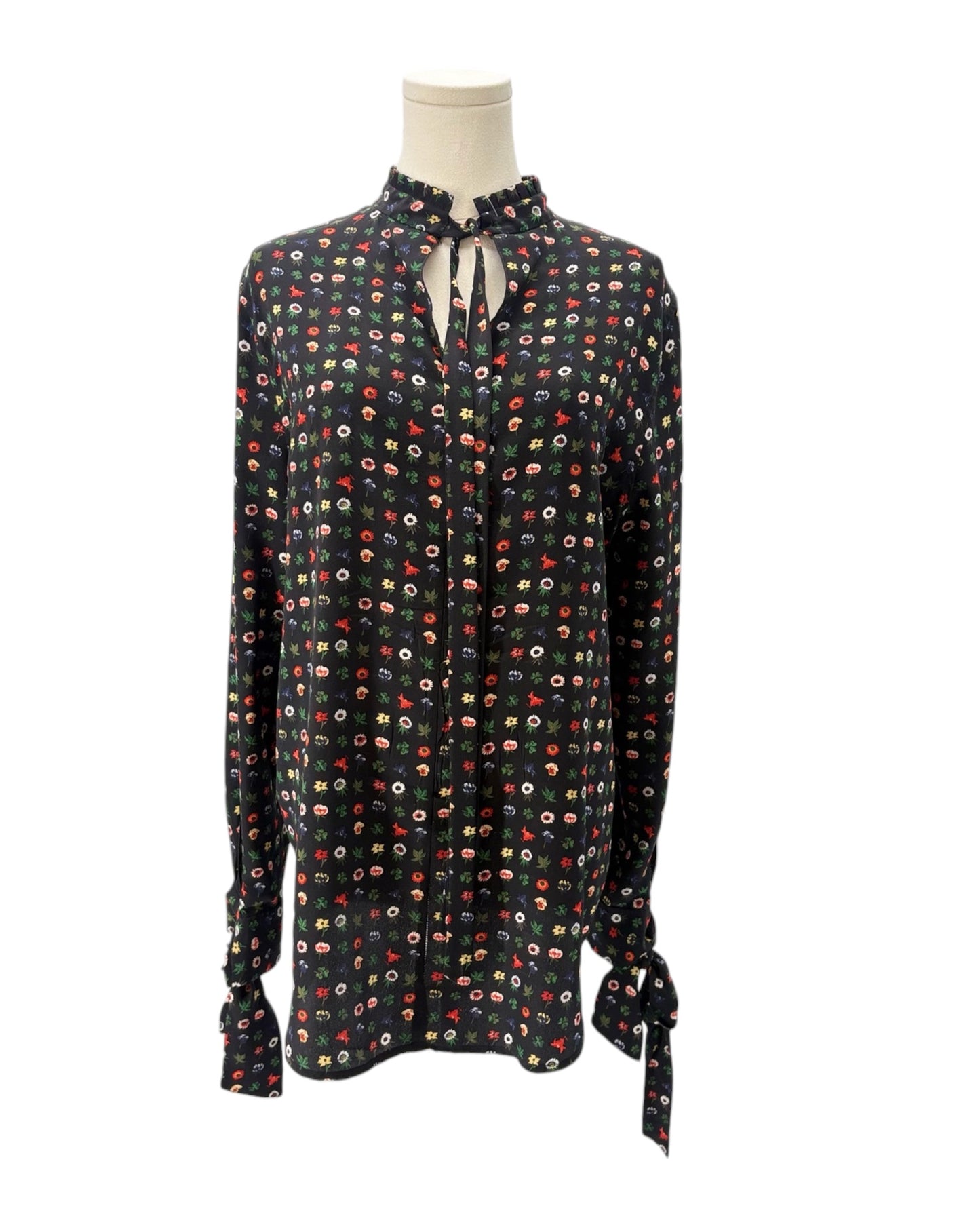 Floral patterned blouse on a mannequin against a white background