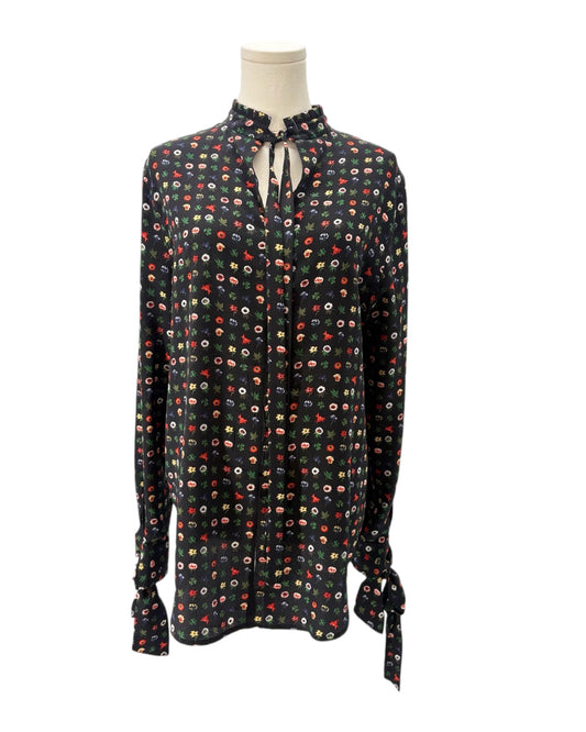 Floral patterned blouse on a mannequin against a white background