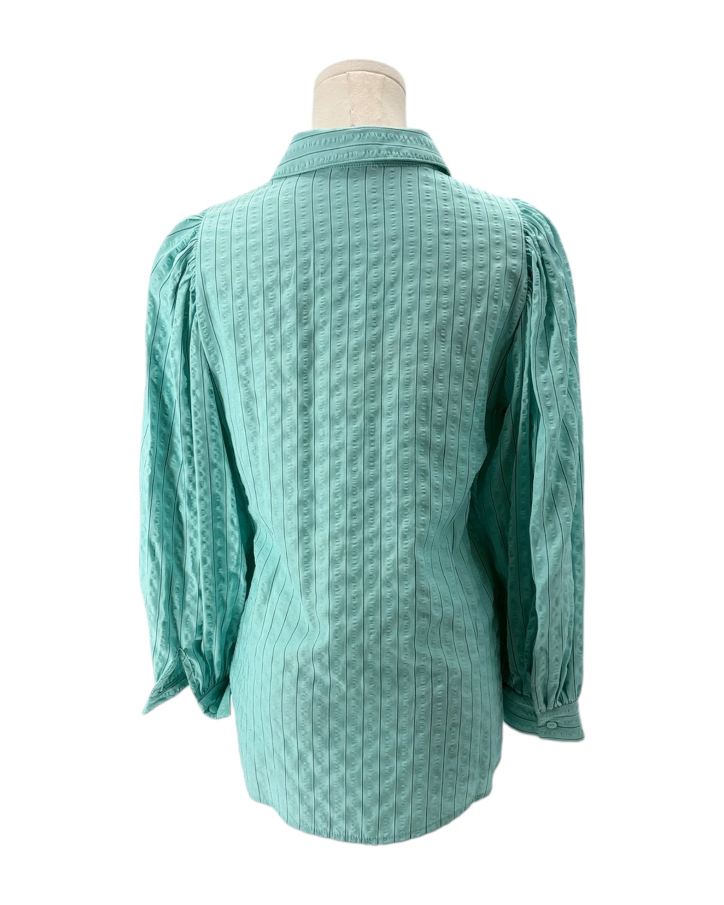 Teal textured blouse on a mannequin against a white background