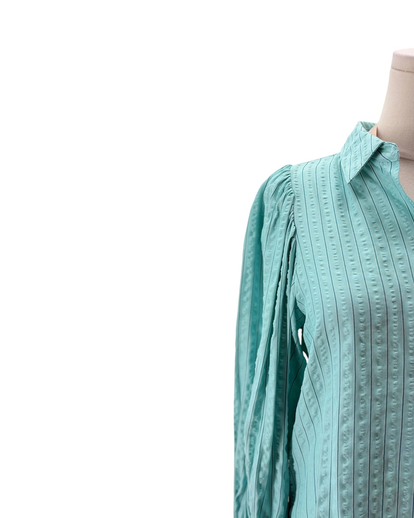 Light blue textured shirt on a mannequin against a white background