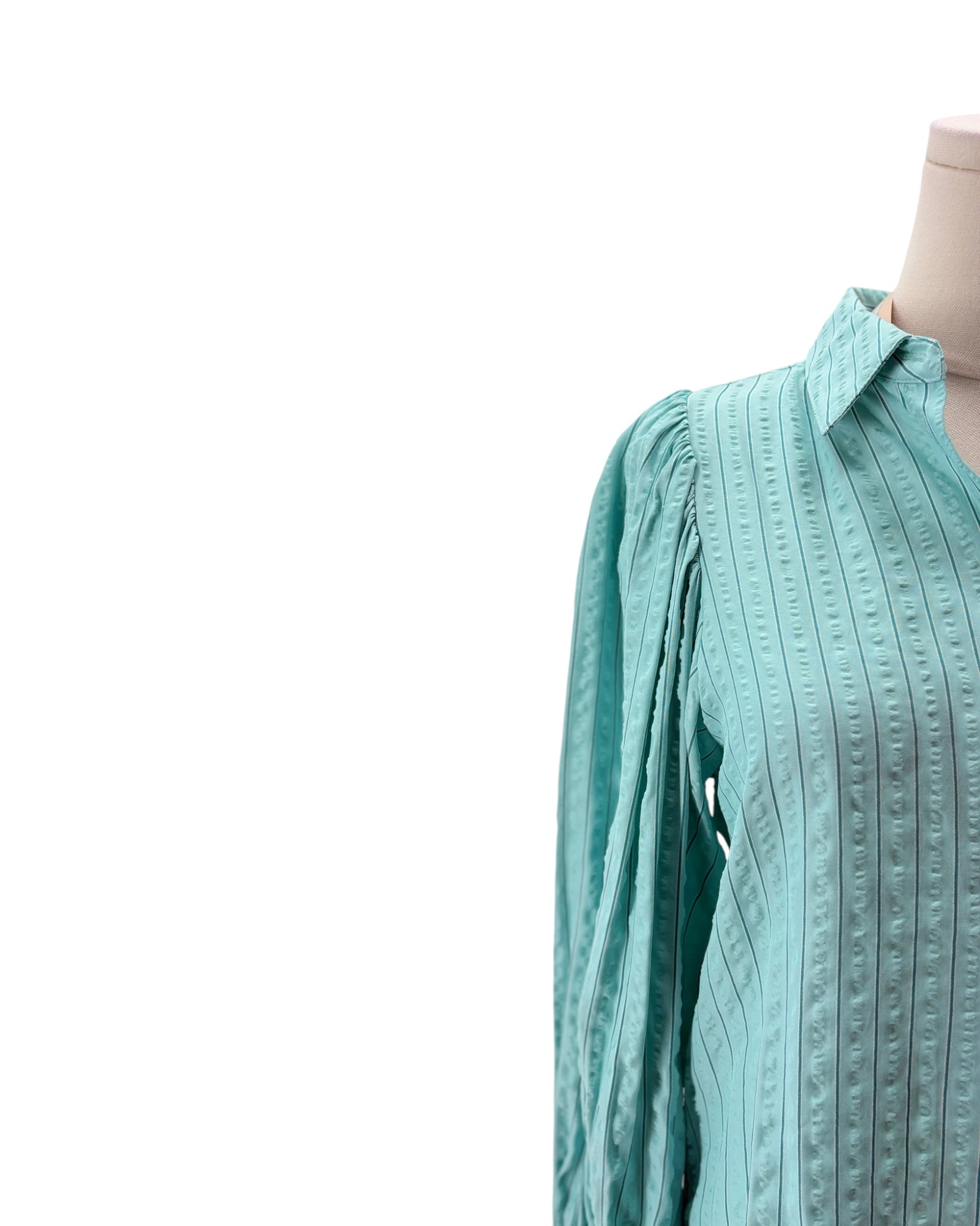 Light blue textured shirt on a mannequin against a white background