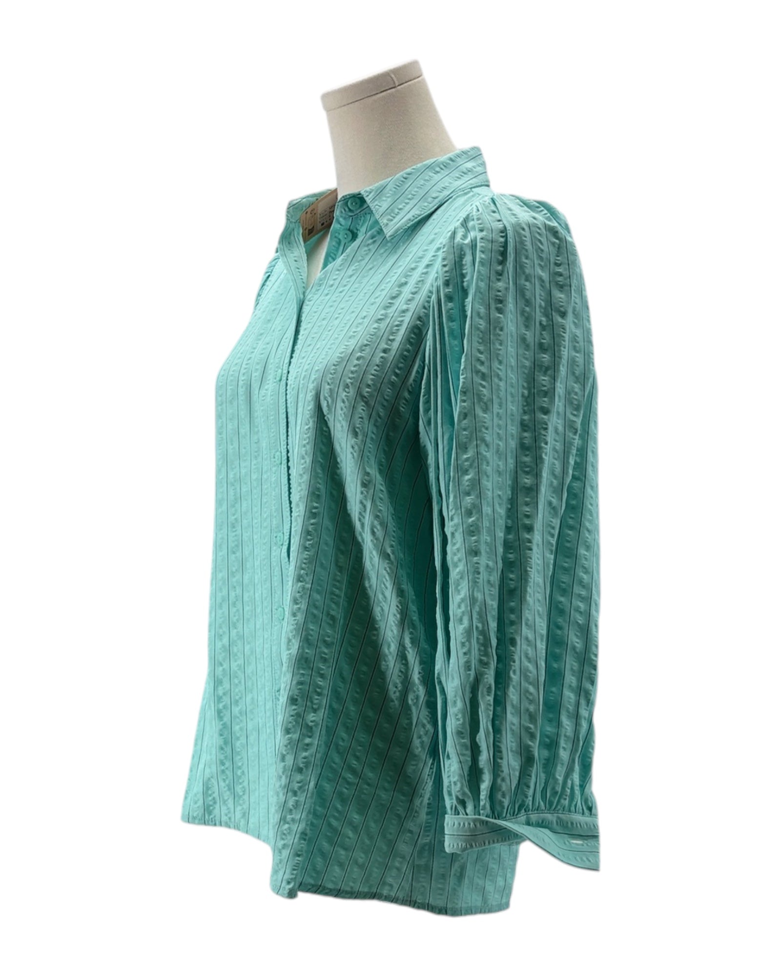 Teal textured shirt on a mannequin against a white background