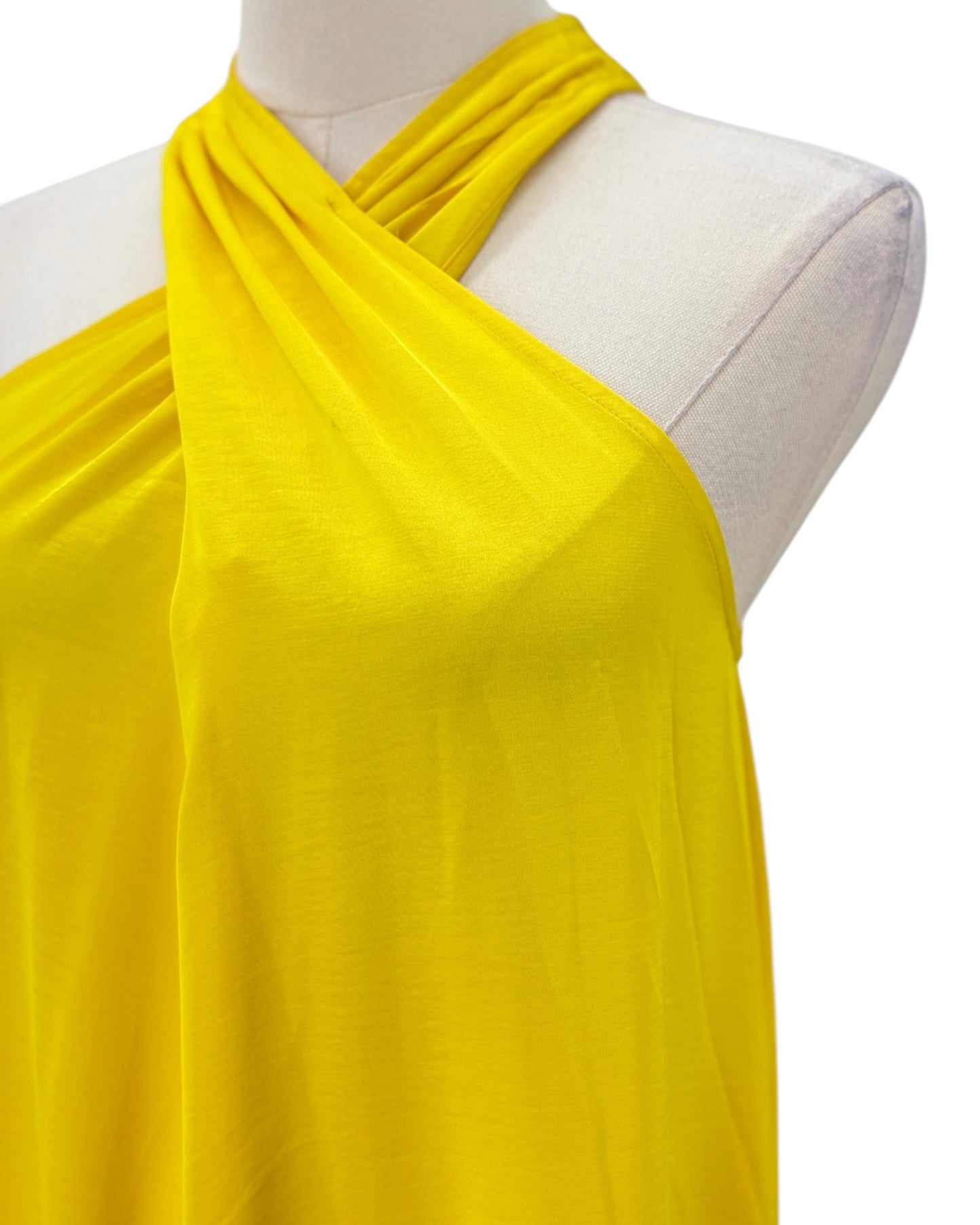Yellow halter dress on a mannequin with a white background
