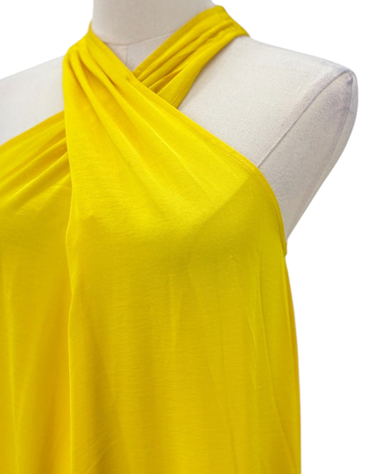 Yellow halter dress on a mannequin with a white background