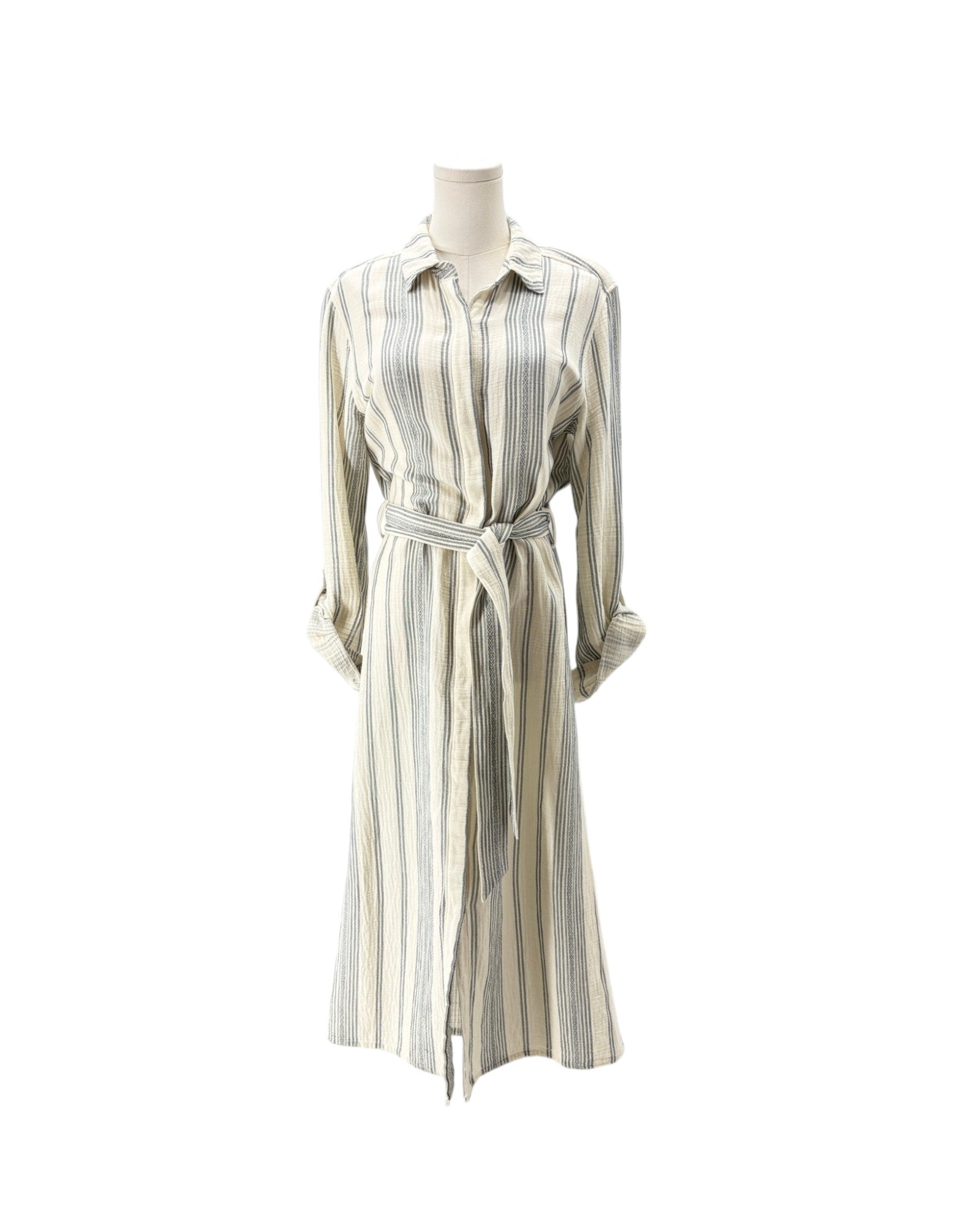 A long-sleeve collared shirt dress with vertical stripes in beige, gray, and muted blue, featuring a matching tie belt, displayed on a mannequin against a plain white background.