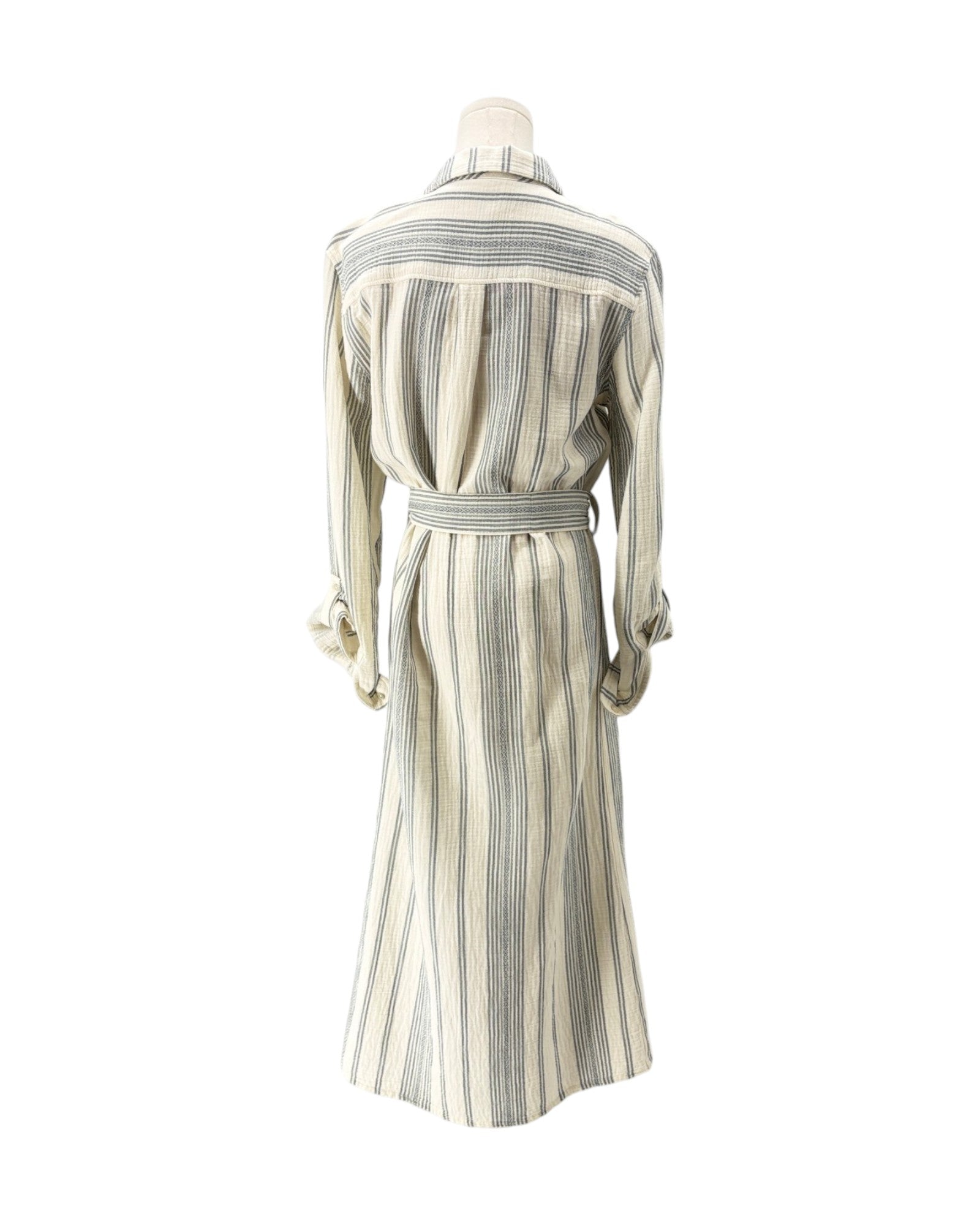 A long-sleeve belted shirt dress with vertical stripes in cream, beige, and gray, displayed on a mannequin from the back against a white background.