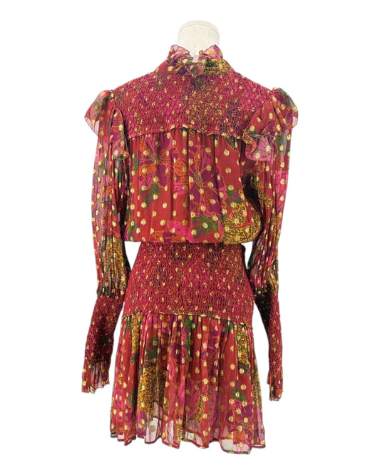 Colorful patterned dress on a mannequin against a white background