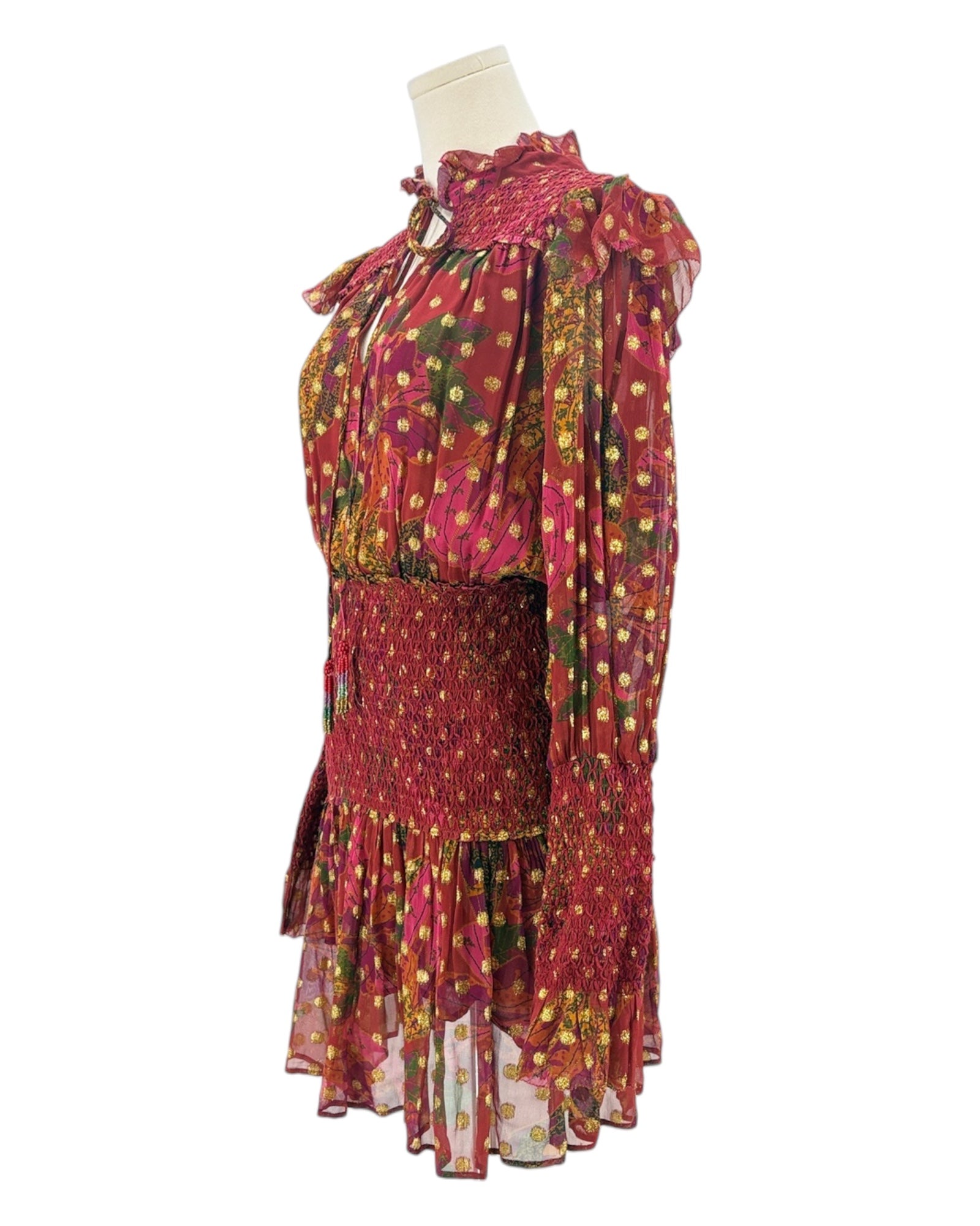 Colorful dress with floral patterns on a mannequin against a white background