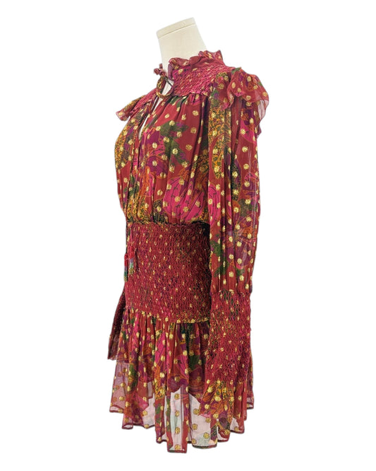 Colorful dress with floral patterns on a mannequin against a white background