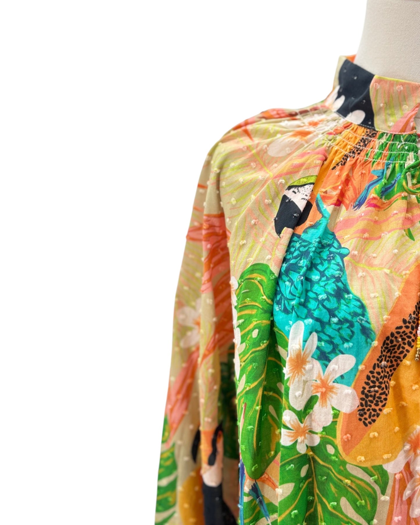 Colorful tropical-themed fabric with parrots and flowers on a white background