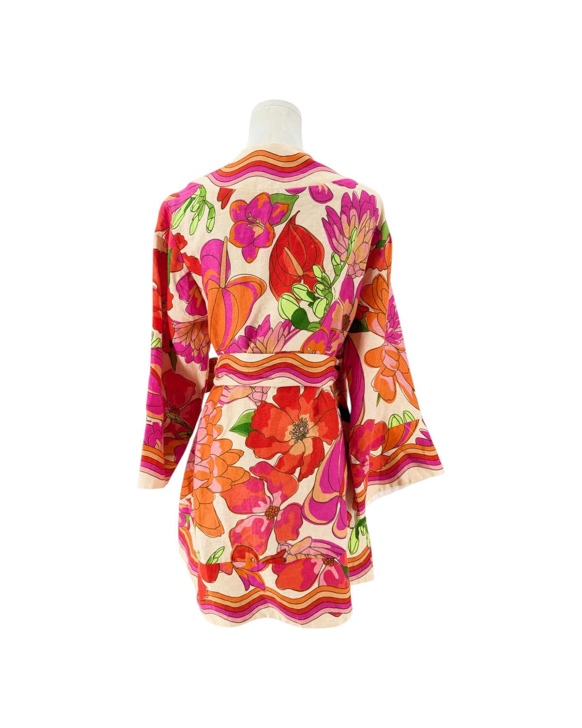 A vintage-style floral mini dress displayed on a mannequin from the back, featuring a bold pattern of red, pink, orange, and green flowers on a cream background with striped borders.