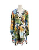 Colorful tropical print dress on a mannequin against a white background