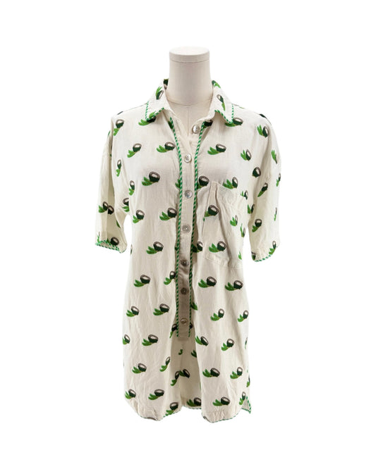 White shirt with green avocado pattern on a mannequin against a white background