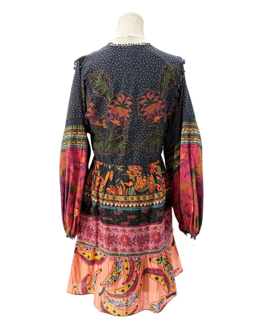 Colorful patterned dress on a mannequin against a white background