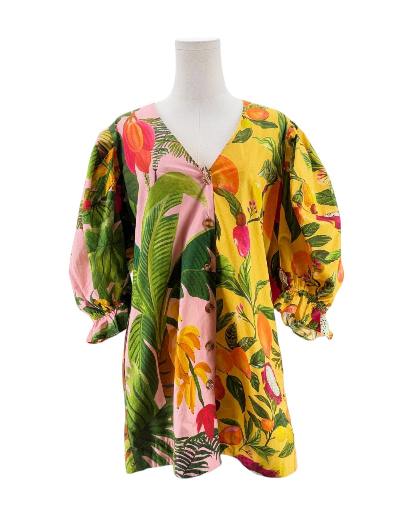 Colorful floral blouse on a mannequin against a white background