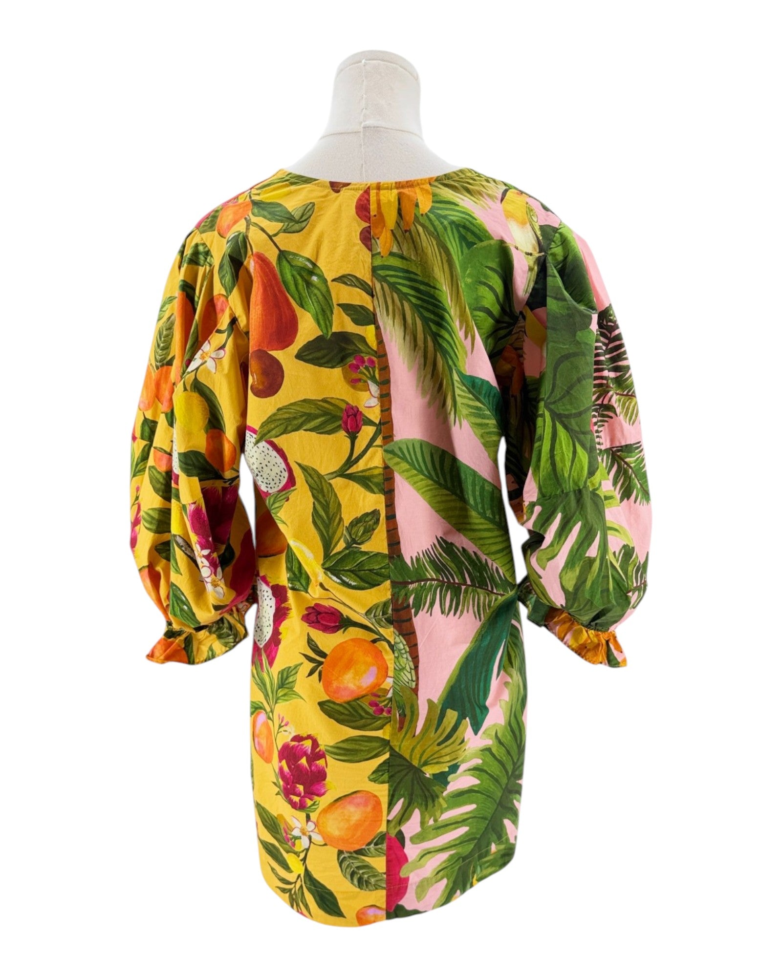 Mannequin wearing a colorful floral dress with a yellow background