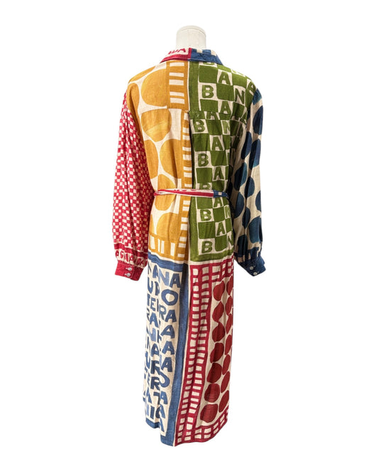 Colorful patterned dress on a mannequin against a white background