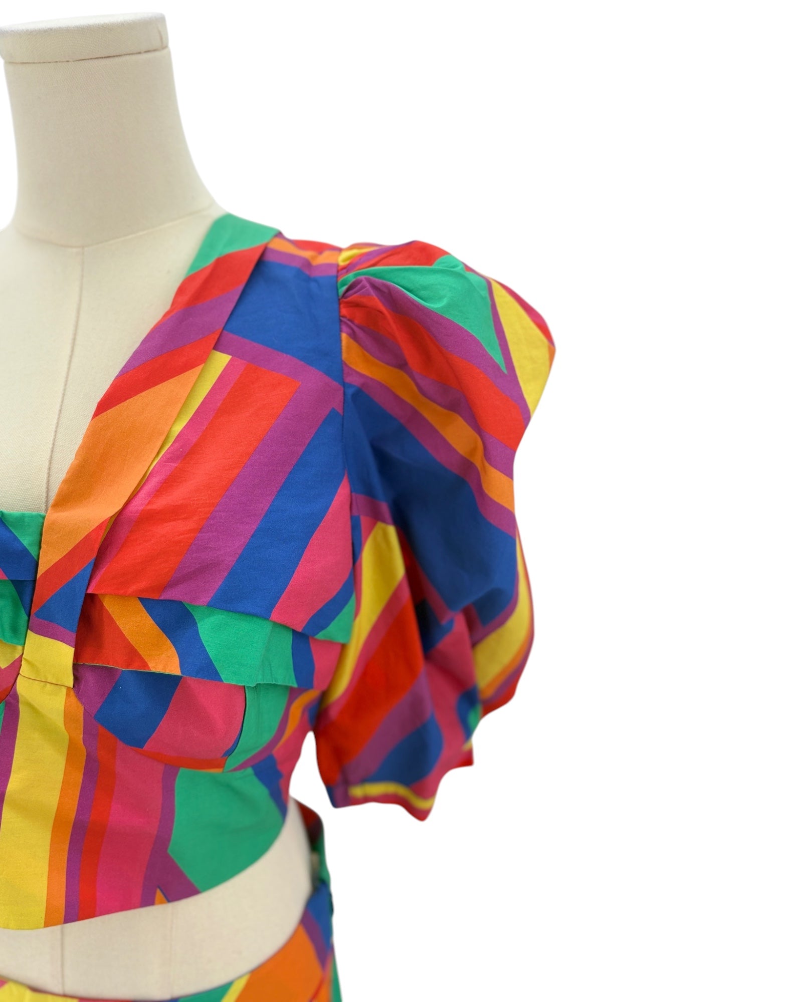 Colorful striped skirt and top on a mannequin against a white background