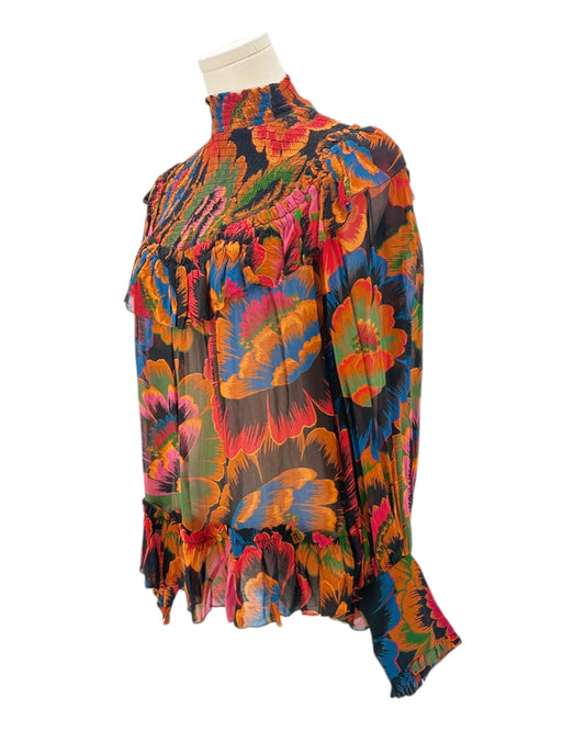 Colorful floral-patterned blouse on a mannequin against a white background