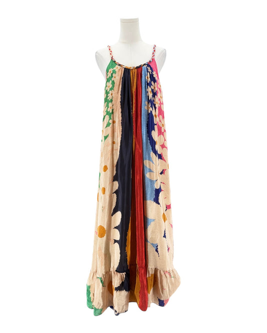 Colorful floral dress on a mannequin against a white background