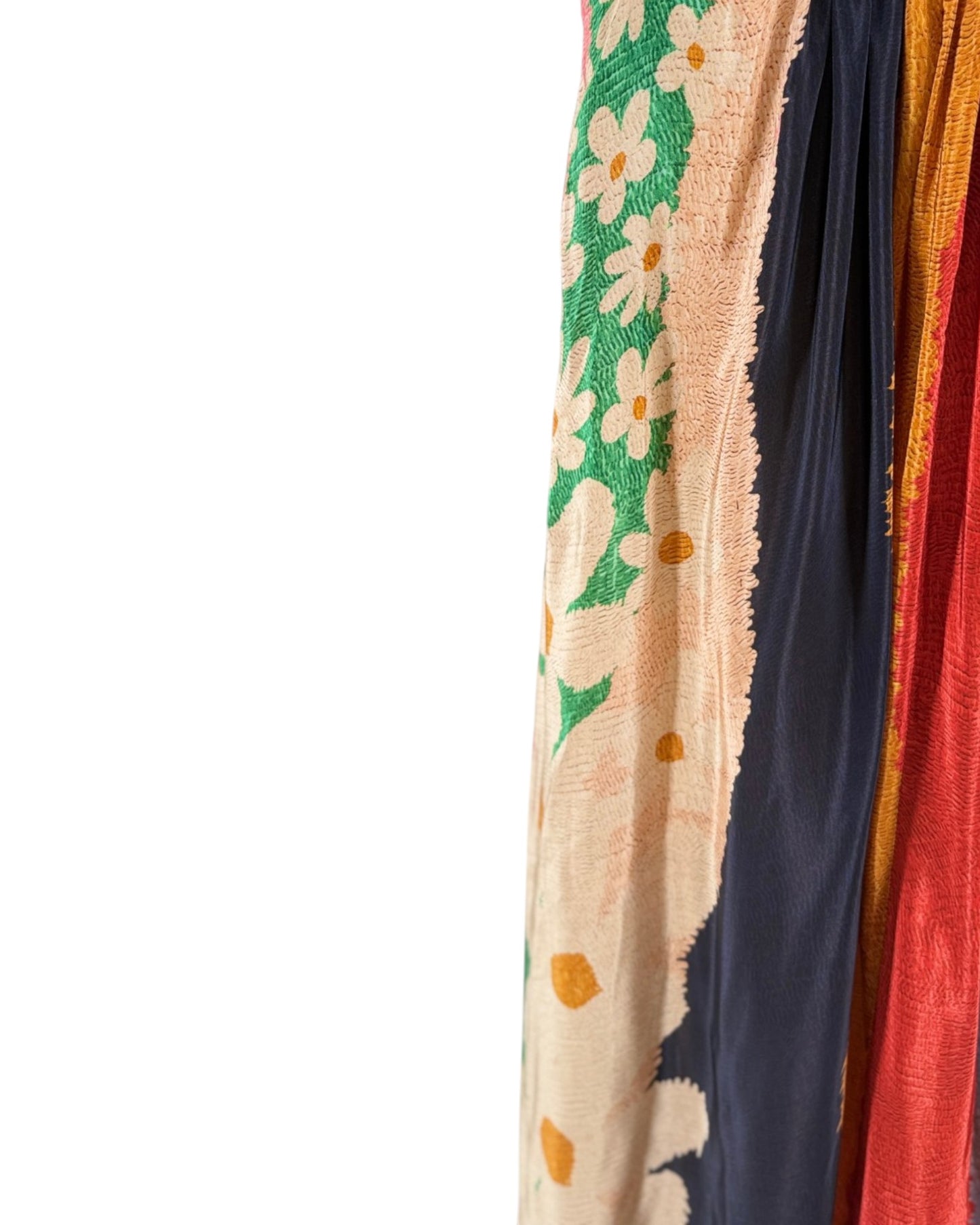 Colorful scarf with floral pattern draped over a white background